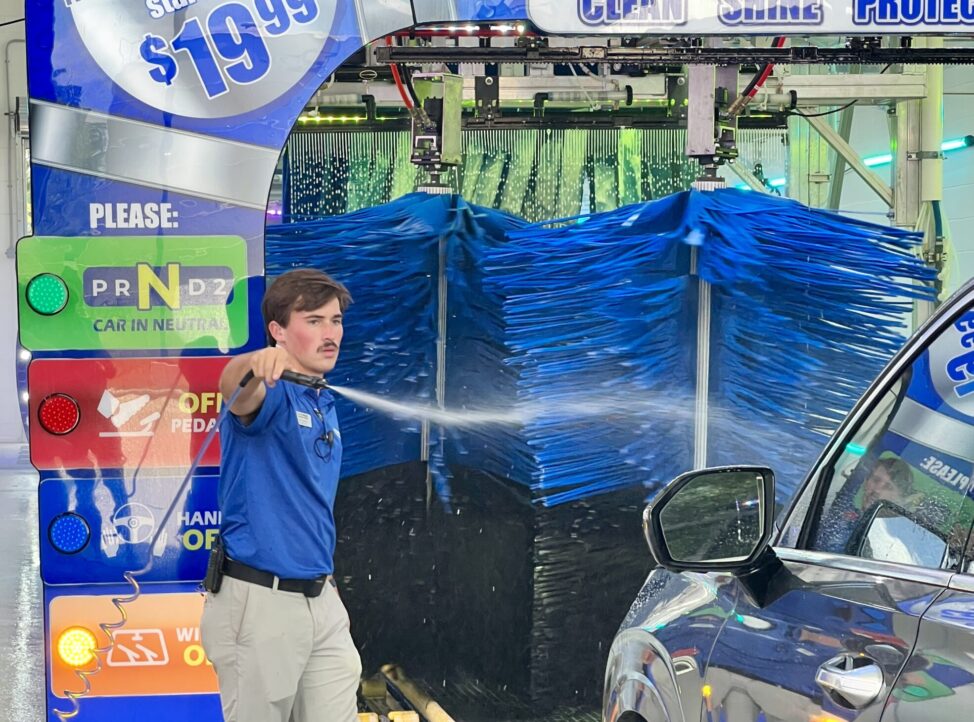 Man washing car with a jetspray at a car wash center in Texas, USA