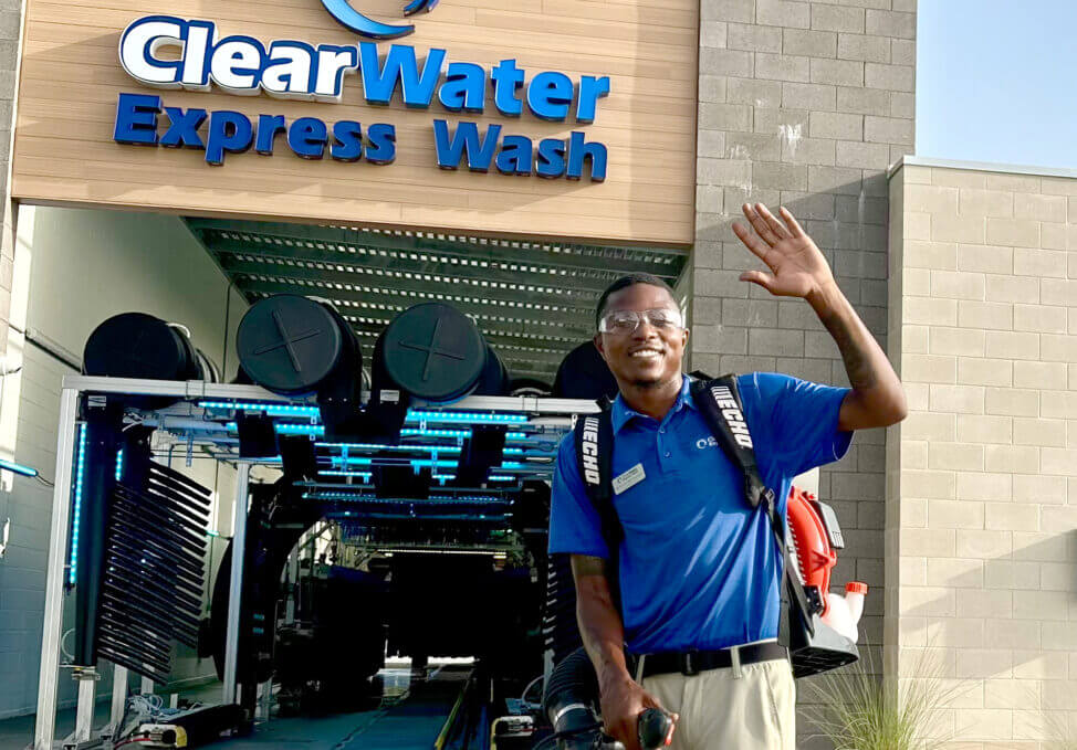 Man Washing car with a Jetspray at a Car Wash Center in Houston Heights, TX